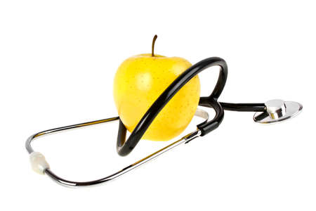Concept for diet and healthcare - yellow apple and stethoscope on a white backgroundの写真素材