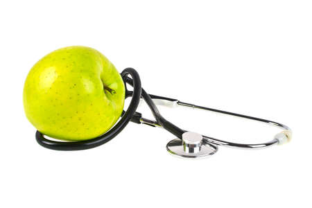 Concept for diet and healthcare - green apple and stethoscope on a white backgroundの写真素材