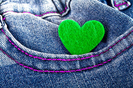 Green heart in jeans pocket