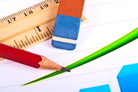 Business concept - red pencil, wooden ruler, eraser and graphの写真素材
