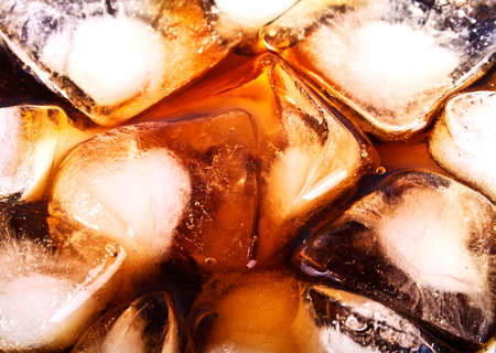 Background of cola with ice cubes and bubbles