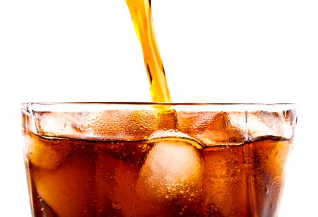 Pouring cola drink to glass with ice, on a white background
