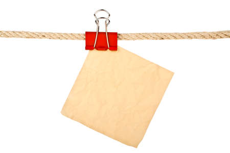 Vintage paper on a rope isolated on white background closeupの写真素材