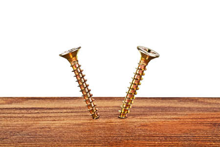 Screws screwed into wooden plankの写真素材