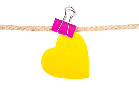Orange paper in shape of heart on a rope isolated on white backgroundの写真素材