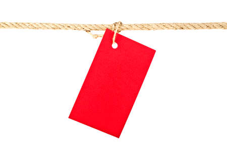 Red lable on a rope isolated on white background, closeupの写真素材