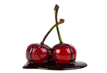 Cherries in chocolate on a white backgroundの写真素材
