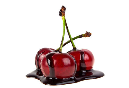 Cherries in chocolate on a white backgroundの写真素材