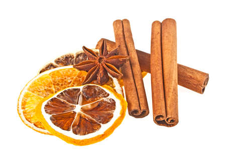 Anise, cinnamon sticks and dried orange and lemon slices on a white background