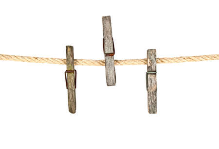 Old wooden clothespins on rope with copy spaceの写真素材