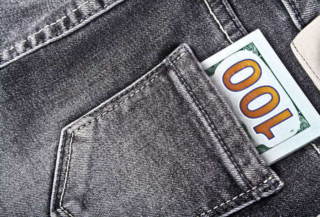 Banknote of one hundred american dollars in jeans pocket