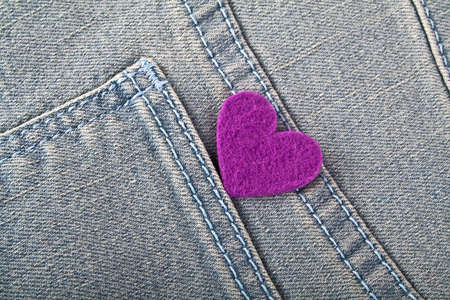 Violet heart in jeans pocketの写真素材