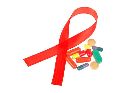 Red AIDS Awareness Ribbon and Pills. AIDS awareness ribbon on white background.の写真素材