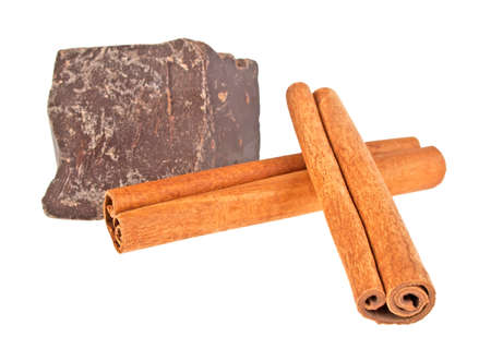 Chocolate bar and cinnamon sticks isolated on white backgroundの写真素材