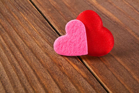 Two colored hearts on a wooden background. Valentines day.の写真素材