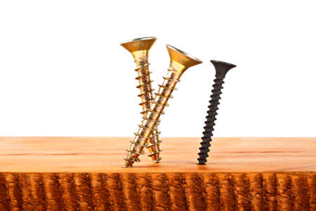 Various screws screwed into wooden plankの写真素材