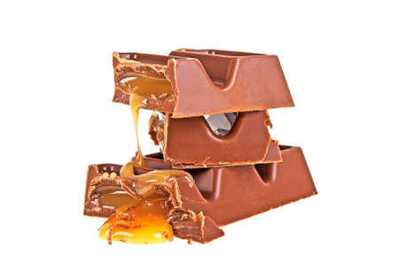 Broken chocolate bar with caramel on a white backgroundの写真素材