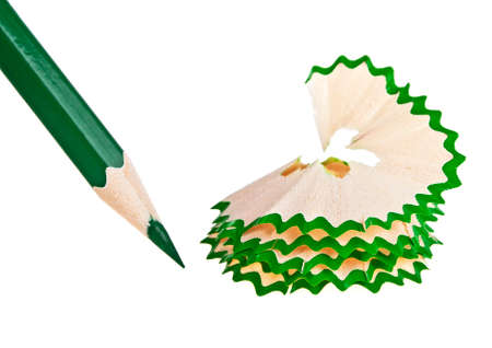 Green pencil with sharpening shavings on a white backgroundの写真素材