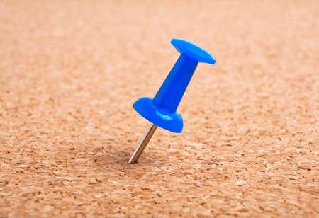 Blue pushpin on cork boardの写真素材