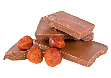 Chocolate with hazelnuts on a white backgroundの写真素材