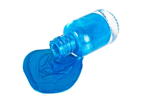 Blue nail polish bottle with splatters isolated on a white backgroundの写真素材