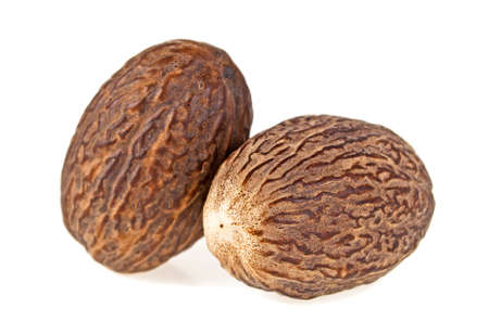 Two dry whole nutmeg isolated on a white backgroundの写真素材