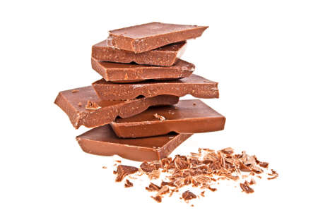 Pile of milk chocolate tiles isolated on a white backgroundの写真素材