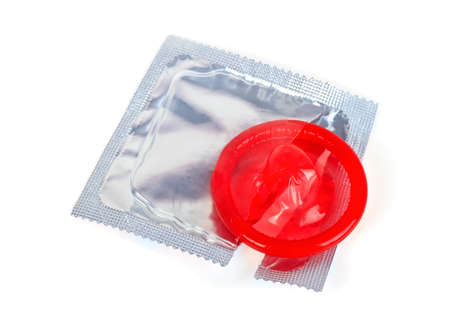 Red condom with open pack isolated on white backgroundの写真素材