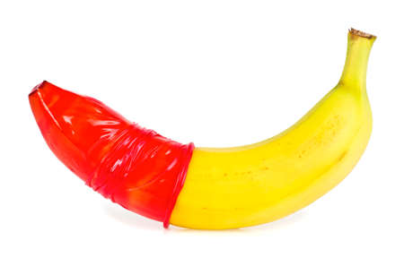 Close-up of banana with red condom isolated on white backgroundの写真素材