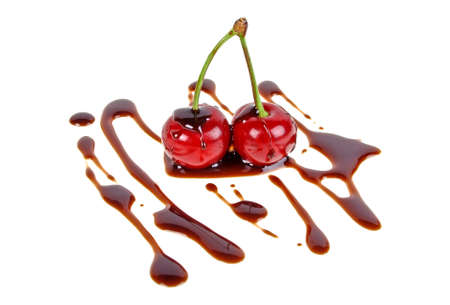 Two cherries in chocolate isolated on white backgroundの写真素材