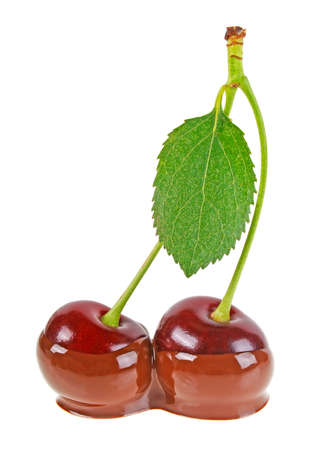 Two cherries in hot milk chocolate on a white backgroundの写真素材