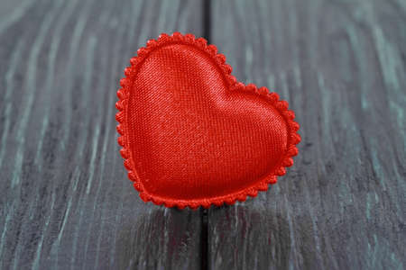 Tissue red heart on a wooden backgroundの写真素材