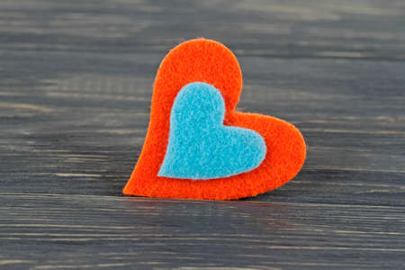 Colored felt heart on wooden backgroundの写真素材