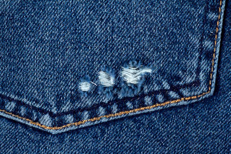 Blue jeans texture or denim background with seam. Pocket of jeans.