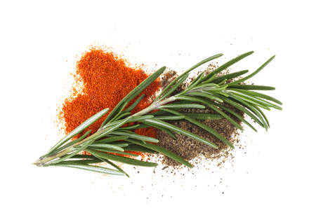 Rosemary branch and pepper powder on a white backgroundの写真素材