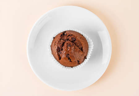 Chocolate muffin on white plate. Top view.の写真素材