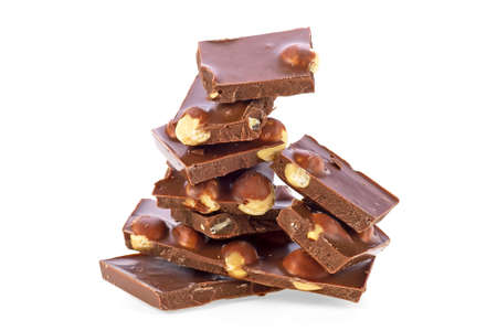 Heap of broken chocolate with nuts on a white background
