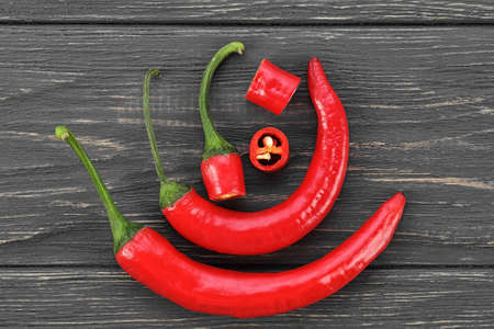Red fresh chilli peppers on wood desk. Food background. の写真素材