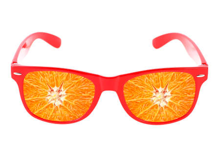 Beach sunglasses concept with orange fruit on white backgroundの写真素材