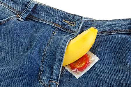 Blue jeans and banana with red condom, safe sex concept.の写真素材
