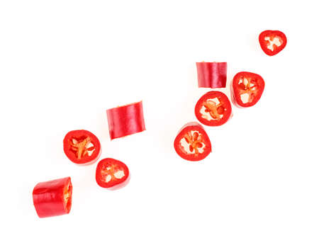 Red chopped chili peppers on white background. Top view.