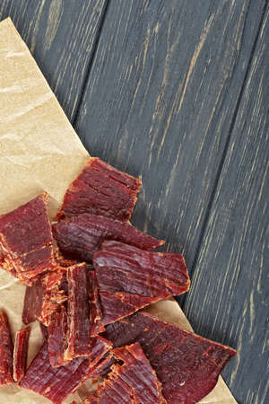 Beef jerky on a wooden board, close-up.の写真素材