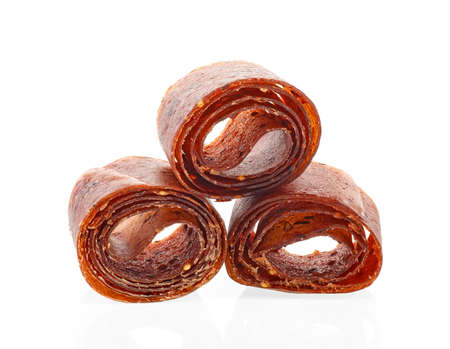 Fruit roll up snack on a white background. Strawberry, currant and apple.の写真素材