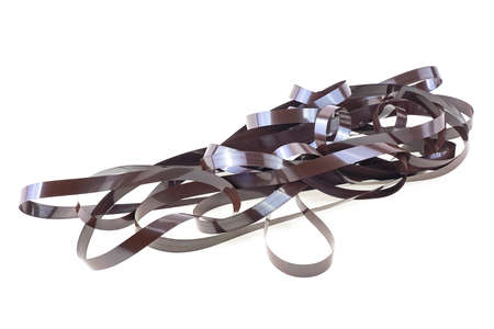 Cassette tape isolated on a white background. Magnetic audio cassette tangle. Reel film.