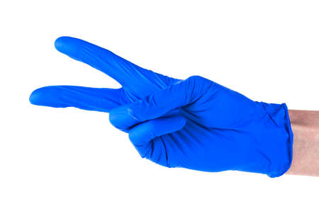 Female hand in blue glove isolated on a white background, showing two fingers.の写真素材