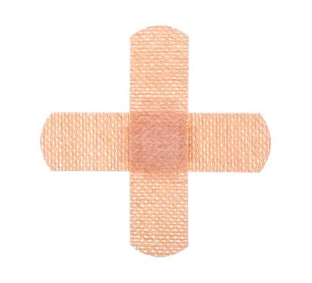 Medical equipment - strips of adhesive bandages plasters. Bandages in shape of a medical plus sign.の写真素材