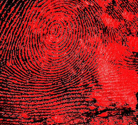Red fingerprint on a black paper, as background.の写真素材