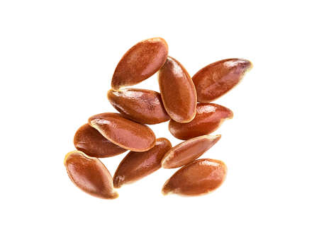 Brown flax seeds isolated on a white background, top view.の写真素材