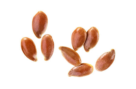 Brown flax seeds isolated on a white background, top view. Linum usitatissimum.の写真素材