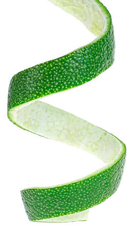Vertical image of lime fruit peel, white background. Lime twist. Lime skin.の写真素材